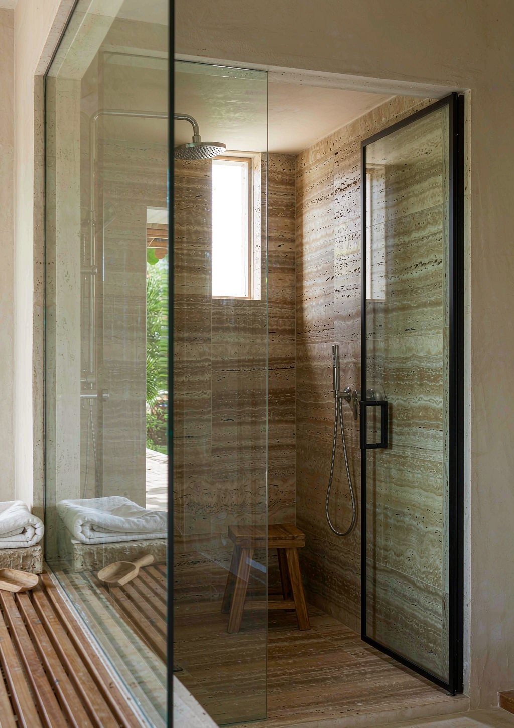 Frameless shower enclosure with a slim stainless frame